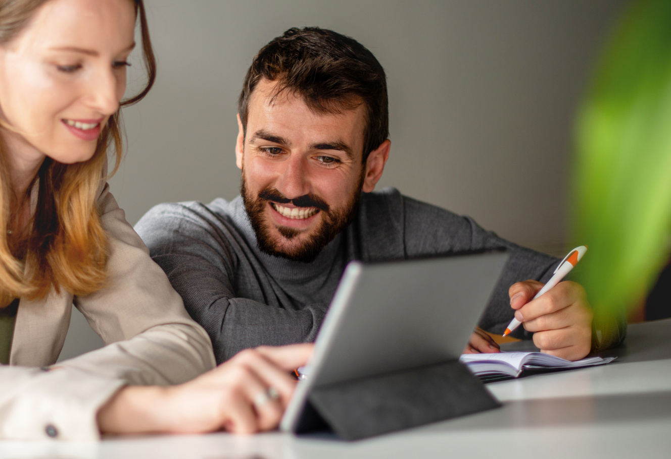 Two people working in office